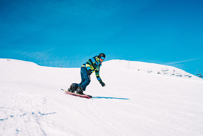 snowboarding under a bluebird sky