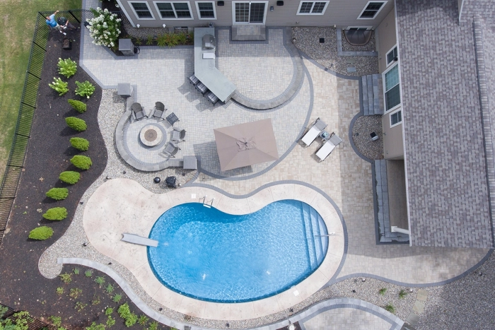 drone picture of patio with an in ground pool