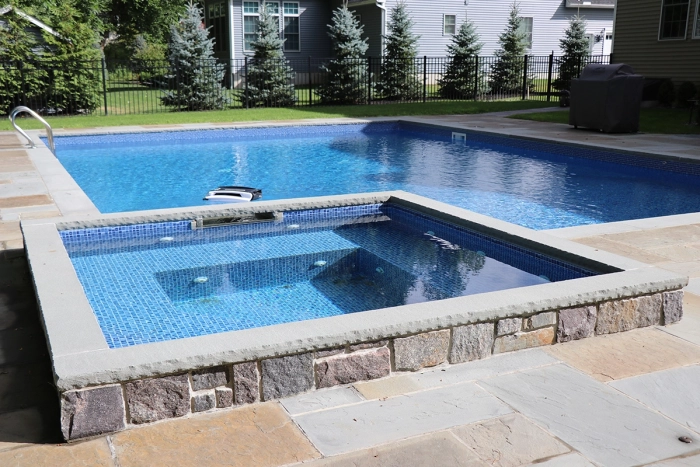 in ground pool with spa